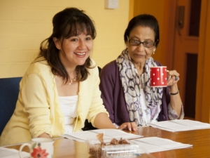 two women with a poem drinking tea